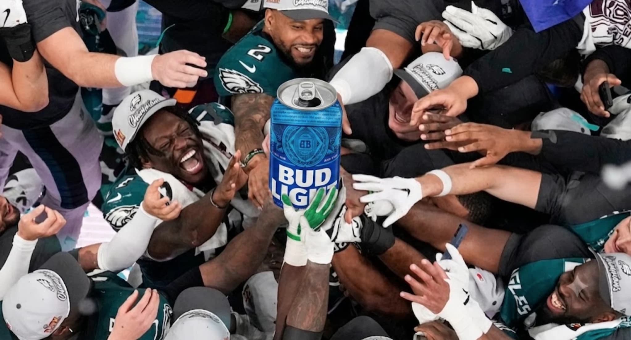 Bud Light football team celebrating around a Bud Light can